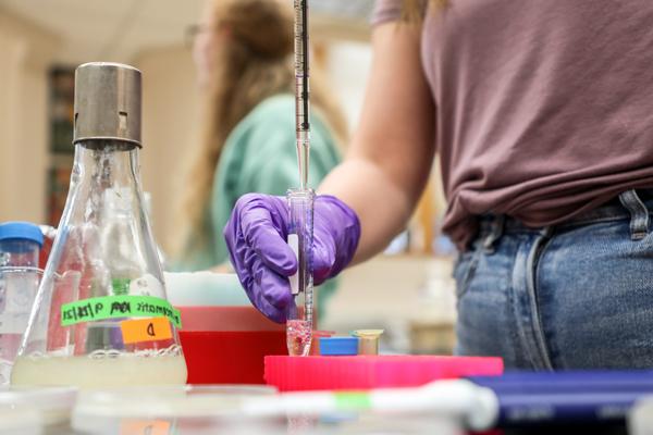 Student injecting fluid into a test tube